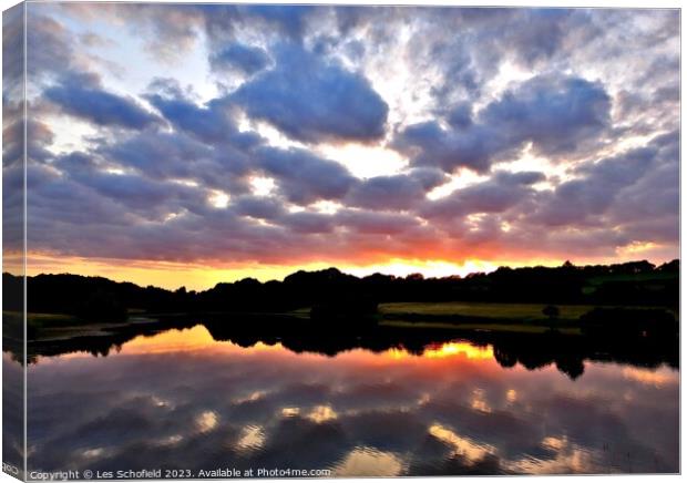 Sunset and lake reflection  Canvas Print by Les Schofield