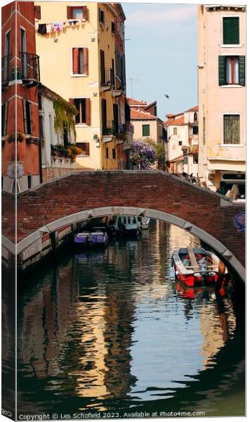 Bridge over canal Venice  Canvas Print by Les Schofield
