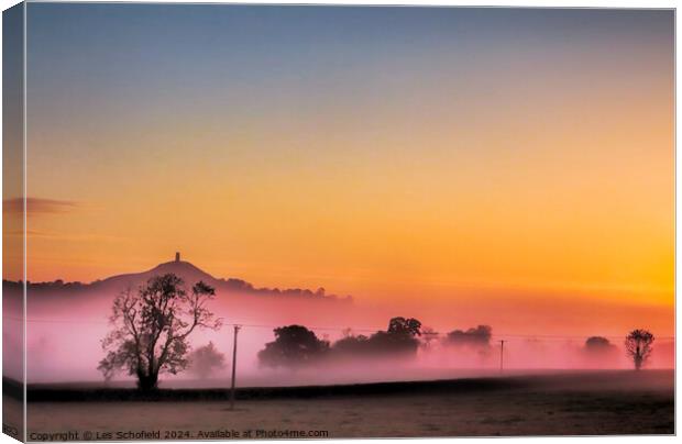 Glastonbury Tor Misty Sunrise Canvas Print by Les Schofield