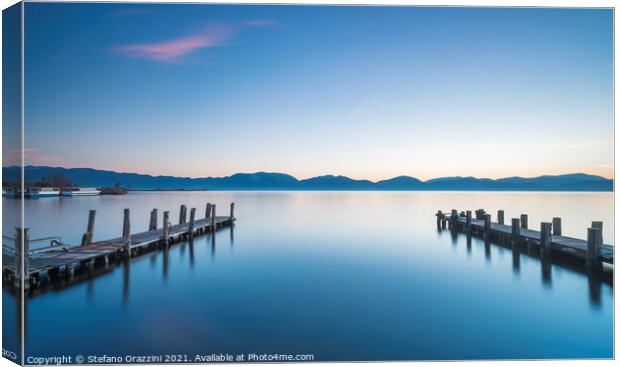Two Wooden piers on a lake Canvas Print by Stefano Orazzini