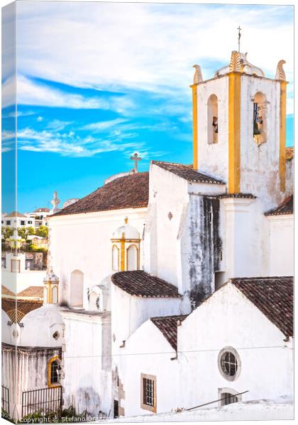 Church and white facades in Tavira, Portugal Canvas Print by Stefano Orazzini