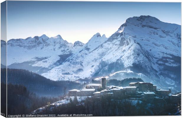 Snowy village and Apuan mountains in winter. Nicciano, Italy Canvas Print by Stefano Orazzini