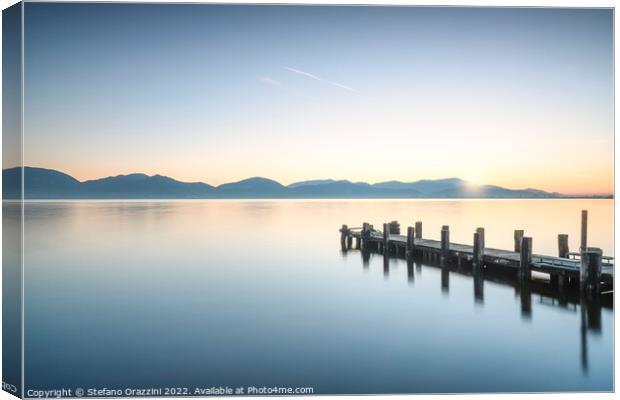 Wooden pier at sunrise. Lake Massaciuccoli Canvas Print by Stefano Orazzini