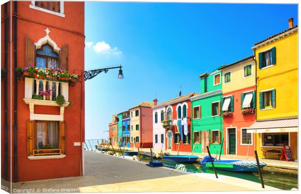Burano island canal, colourful houses and boats. Canvas Print by Stefano Orazzini