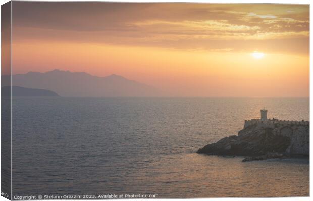 Lighthouse of Piombino at sunset and Elba island. Canvas Print by Stefano Orazzini