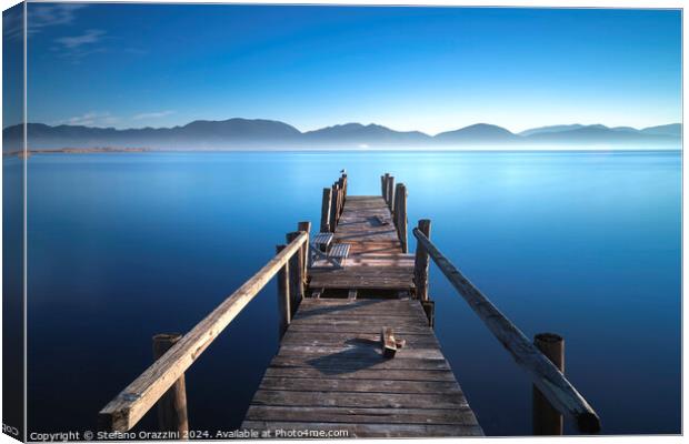 Wooden pier at sunrise. Lake Massaciuccoli, Tuscany, Italy Canvas Print by Stefano Orazzini