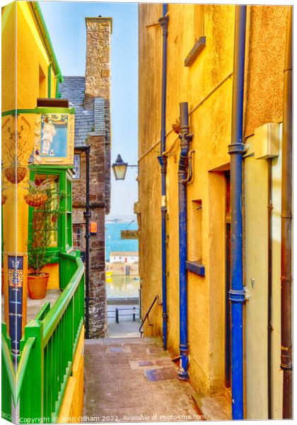 Narrow Colourful Lane to the sea in Tenby Wales Canvas Print by John Gilham