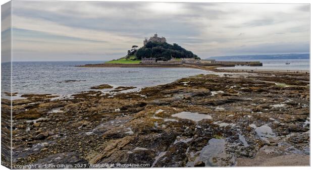 St Michaels Mount Marazion Cornwall England UK seen from a rocky outcrop on the mainland beach Canvas Print by John Gilham