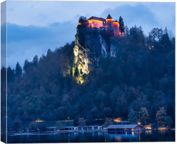 Lit Up Castle Bled on Lake Bled during Blue Hour. Canvas Print by Maggie Bajada