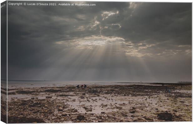 Sunrays through a gap in the overcast sky with black clouds with Canvas Print by Lucas D'Souza