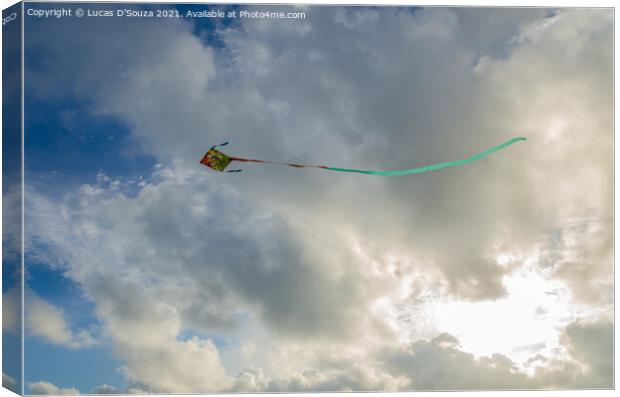 Kite flying against backdrop of beautiful clouds Canvas Print by Lucas D'Souza