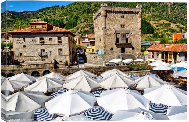 Castle and Parasols in Potes Canvas Print by Roger Mechan