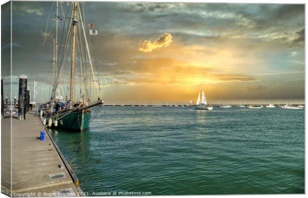 Lone Yacht Sailing Towards the Solent Canvas Print by Roger Mechan