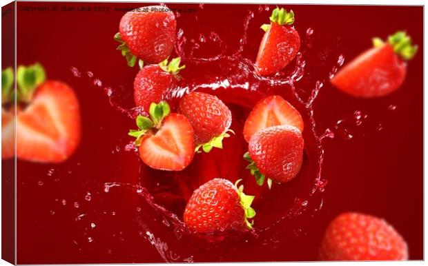 Strawberry falling into the lot of juice Canvas Print by Stan Lihai
