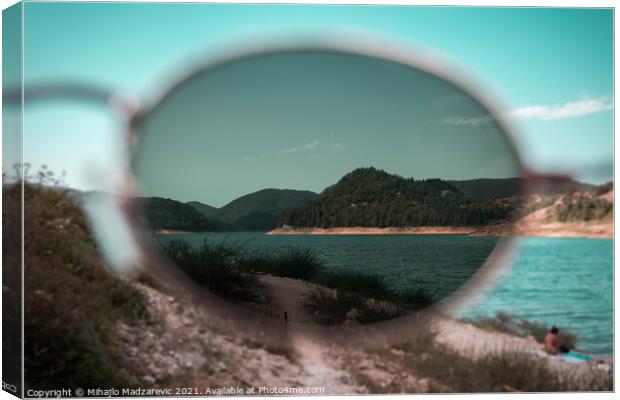 Focus view of mountain nature and a lake through s Canvas Print by Mihajlo Madzarevic