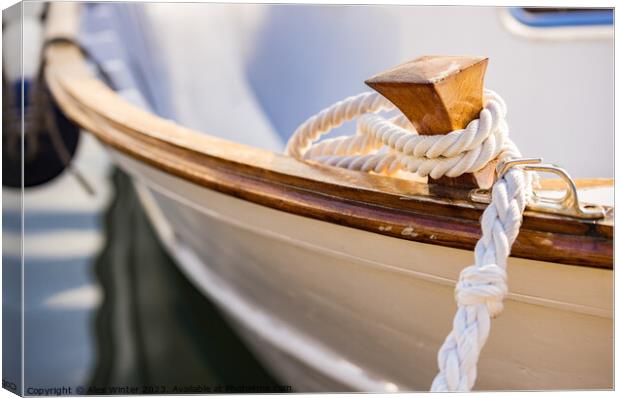 White mooring rope is knotted on boat cleat Canvas Print by Alex Winter