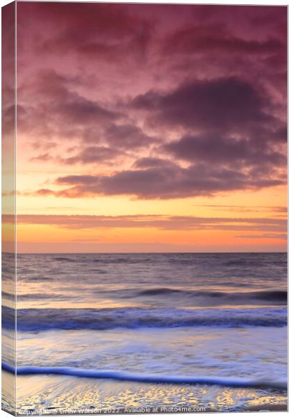 Sunrise over the sea Canvas Print by Drew Watson