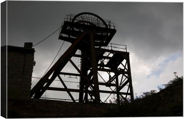 Silhouette of abandoned pit head winding gear, South Wales Canvas Print by Gordon Dixon