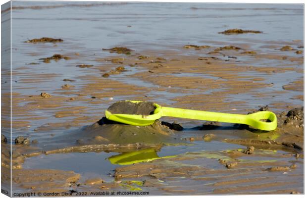 Abandoned yellow spade on Weymouth beach Canvas Print by Gordon Dixon