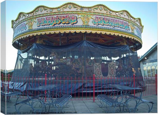Carousel and it's horses put to bed for the winter at a funfair in Weymouth Canvas Print by Gordon Dixon