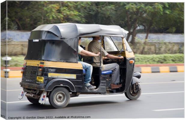 Autorickshaw driving down a road with passenger - Delhi, India Canvas Print by Gordon Dixon