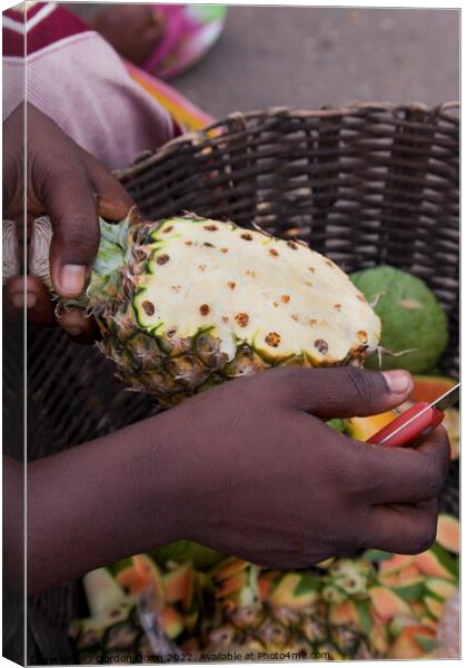 Preparing a pineapple for eating - roadside seller, Ghana Canvas Print by Gordon Dixon