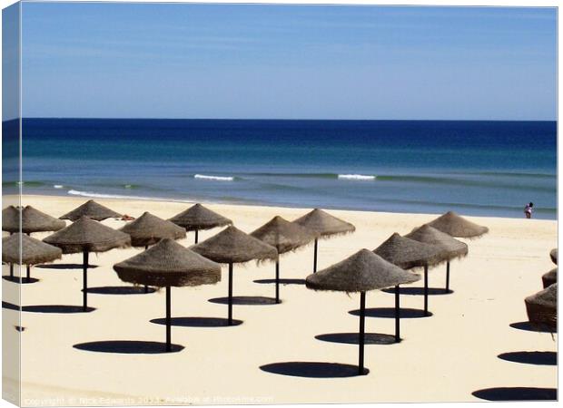 Algarve Beach Umbrellas in Rows Canvas Print by Nick Edwards