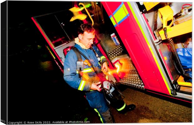 Firefighter in breathing apparatus and fire appliance with blurred lights at a fire Canvas Print by Rose Sicily