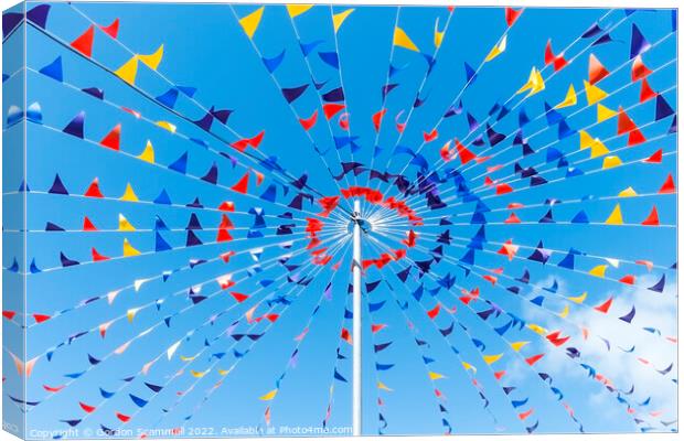 Colourful bunting against a blue sky. Canvas Print by Gordon Scammell
