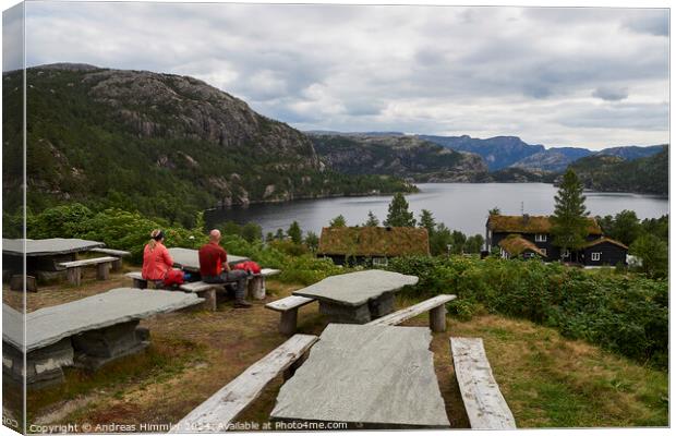 A couple relaxes at Preikestolen Base Camp with a view of Lake R Canvas Print by Andreas Himmler