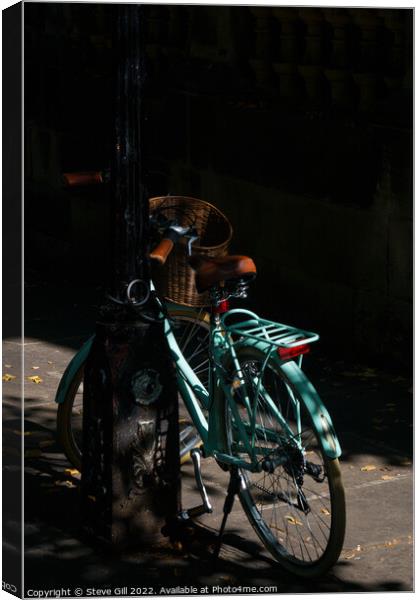 Vintage Style Turquoise Ladies Bicycle Locked to a an urban Lamp Post. Canvas Print by Steve Gill