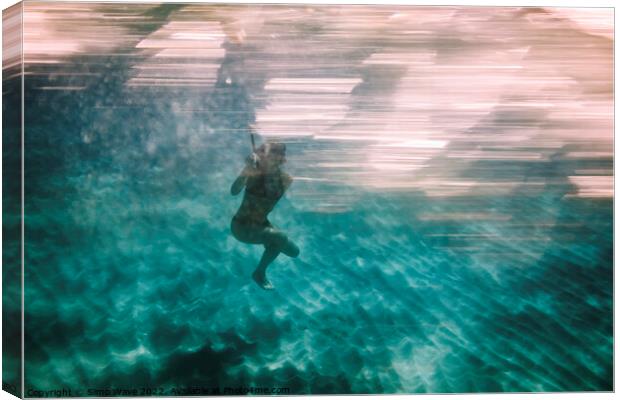 Woman diving underwater for snorkeling Canvas Print by Simo Wave