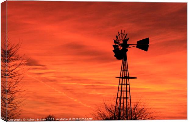 Kansas Sunset with red sky and a Windmill silhouet Canvas Print by Robert Brozek