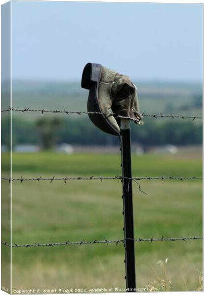 Cowboy boot on a fence with grass Canvas Print by Robert Brozek