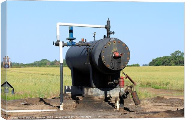 Oil Well Storage Equipment in a field Canvas Print by Robert Brozek