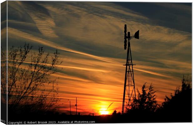 Sunset with an orange sky and Windmill silhouette Canvas Print by Robert Brozek