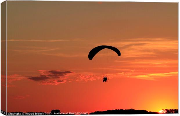 Paraglider at Sunset with a colorful sky. Canvas Print by Robert Brozek