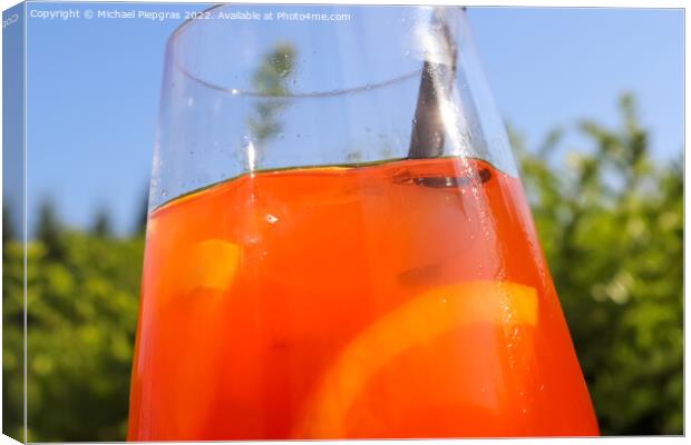 Refreshing orange summer cocktails with ice against a blue sky b Canvas Print by Michael Piepgras