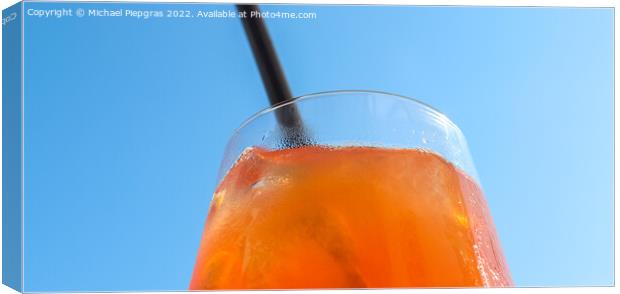 Refreshing orange summer cocktails with ice against a blue sky b Canvas Print by Michael Piepgras