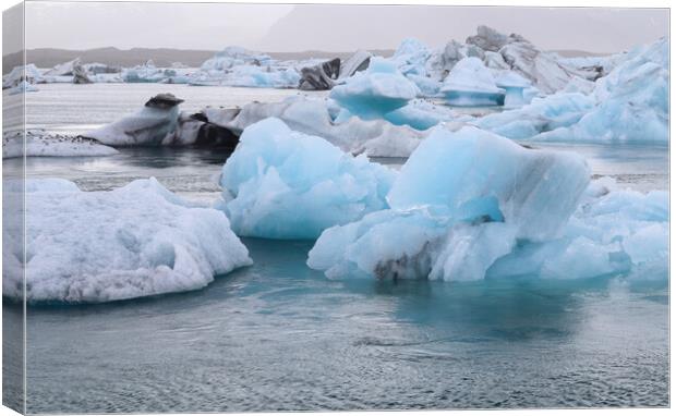 Iceland, Jokulsarlon Lagoon, Turquoise icebergs floating in Glacier Lagoon on Iceland. Canvas Print by Michael Piepgras