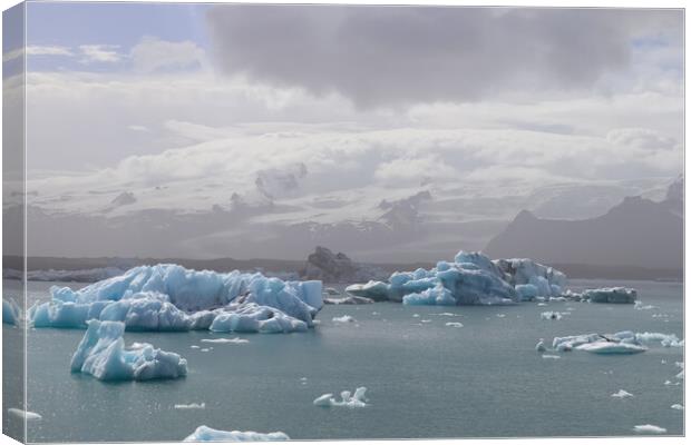 Iceland, Jokulsarlon Lagoon, Turquoise icebergs floating in Glacier Lagoon on Iceland. Canvas Print by Michael Piepgras