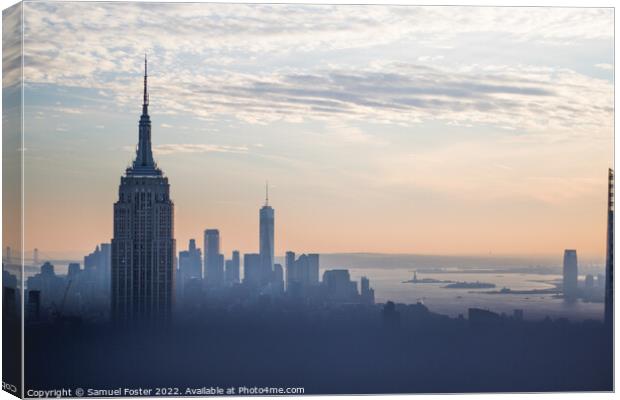 Empire State building at sunset from the Top of th Canvas Print by Samuel Foster