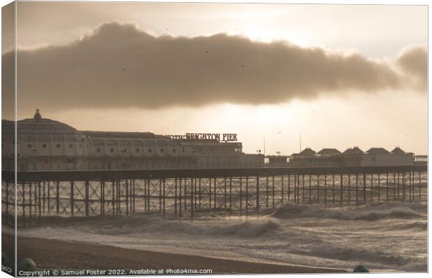 Brighton Pier on a stormy windy day with sun coming through clouds Canvas Print by Samuel Foster