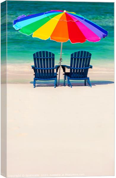 Bahamas colorful sun umbrella and two beach beds  Canvas Print by Spotmatik 