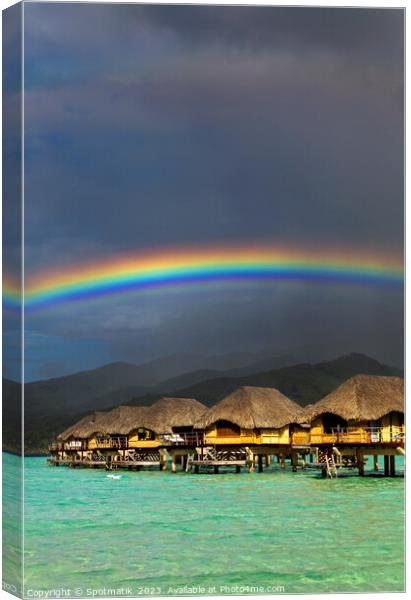 Rainbow arch over Bora Bora luxury Overwater bungalows  Canvas Print by Spotmatik 