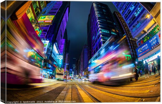 Hong Kong illuminated busy street intersection Kow Canvas Print by Spotmatik 