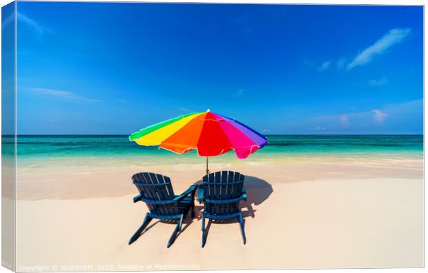 Parasol and chairs on sandy beach Bahamas Caribbean Canvas Print by Spotmatik 
