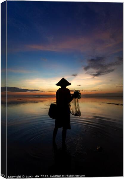 Balinese male fishing at sunrise Flores sea coastline  Canvas Print by Spotmatik 