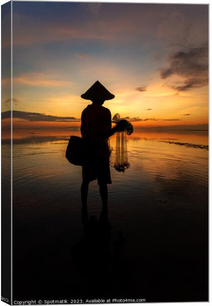 Silhouette Balinese male fishing Indonesian coastline at sunrise Canvas Print by Spotmatik 