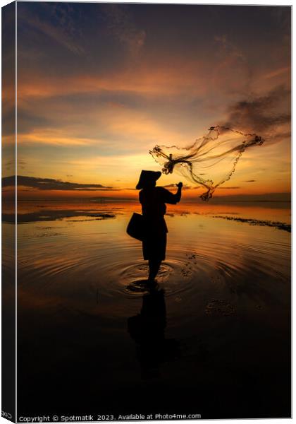 Balinese fisherman casting net Flores sea at sunrise Canvas Print by Spotmatik 